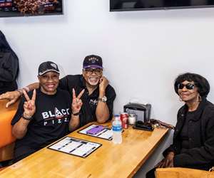 Happy guests enjoying a meal at Black Pizza. 