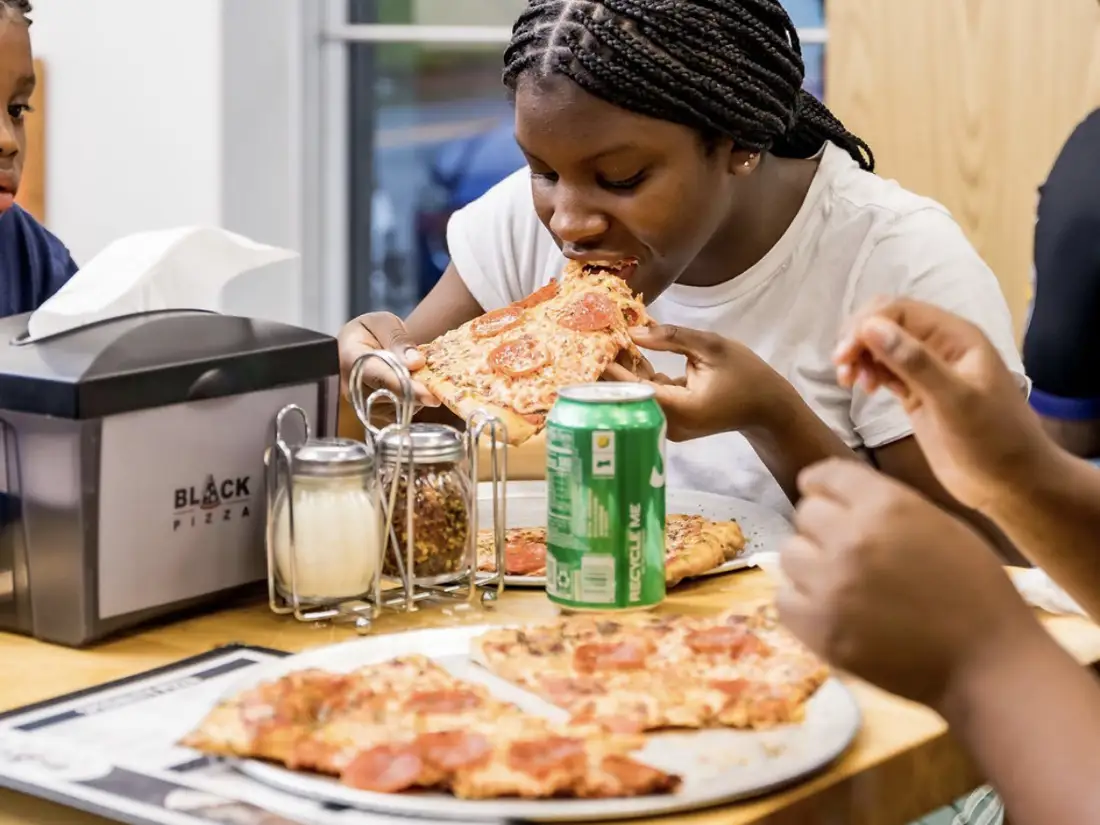 Neighbors and friends enjoying Black Pizza on Joseph E. Boone Boulevard NW in Atlanta. 