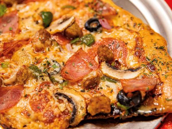 Delicious Black Pizza with olives, ham and peppers, serving Atlanta. 