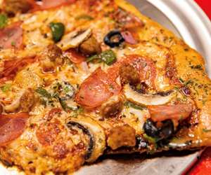 Delicious Black Pizza with olives, ham and peppers, serving Atlanta. 